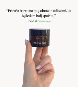 a hand holding a small jar