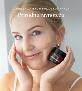 a woman holding a jar of cream