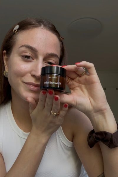 a woman holding a jar of cream